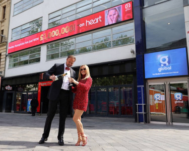 LONDON, ENGLAND - MAY 28:  Amanda Holden and Jamie Theakston posing outside Heart Radio Studios as t