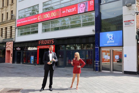 LONDON, ENGLAND - MAY 28:  Amanda Holden and Jamie Theakston posing outside Heart Radio Studios as t